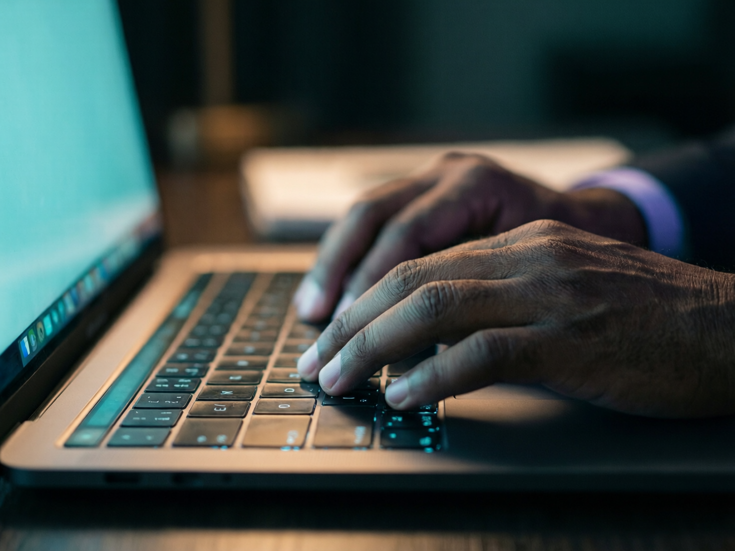Two hands over a keyboard — close-up of thoughtful senior engineering work